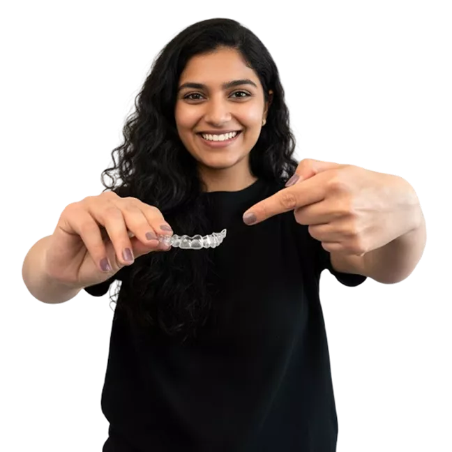 Smiling woman holding custom clear invisible aligners for orthodontic treatment at Dr. Pawar's Advanced Dentistry in Thane West.